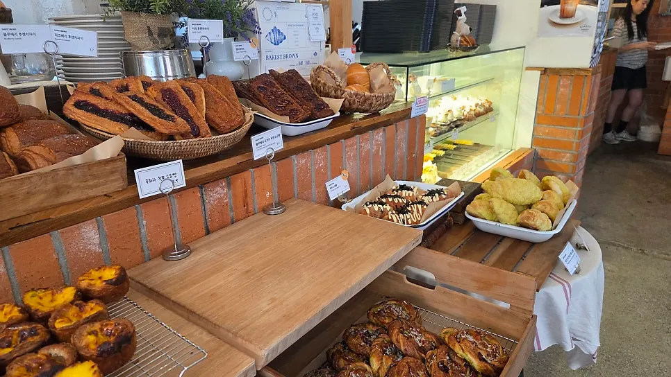 Display case with egg tarts and sausage bread