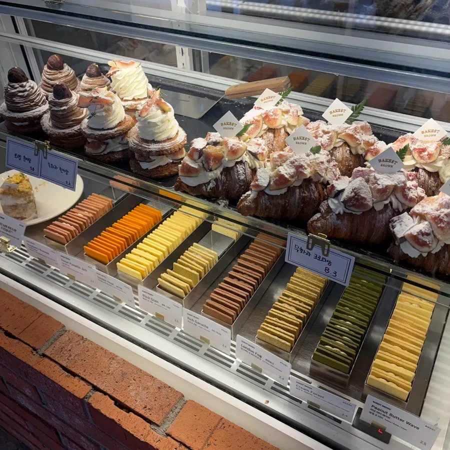 Cakes and butter sandwiches in a refrigerated case