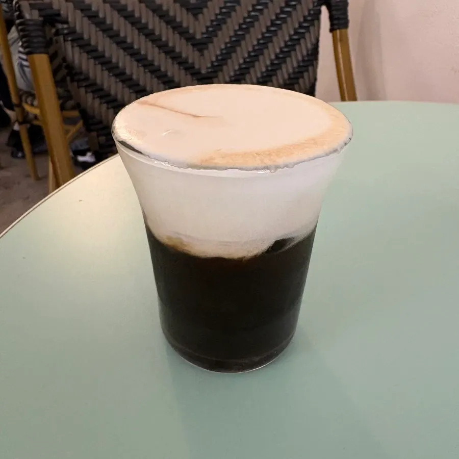 A cup of salt cream coffee topped with cream