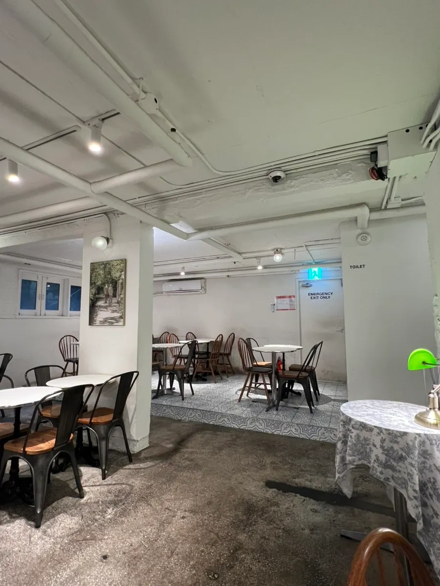 Half-basement seating on basement level 1 with a window view outside