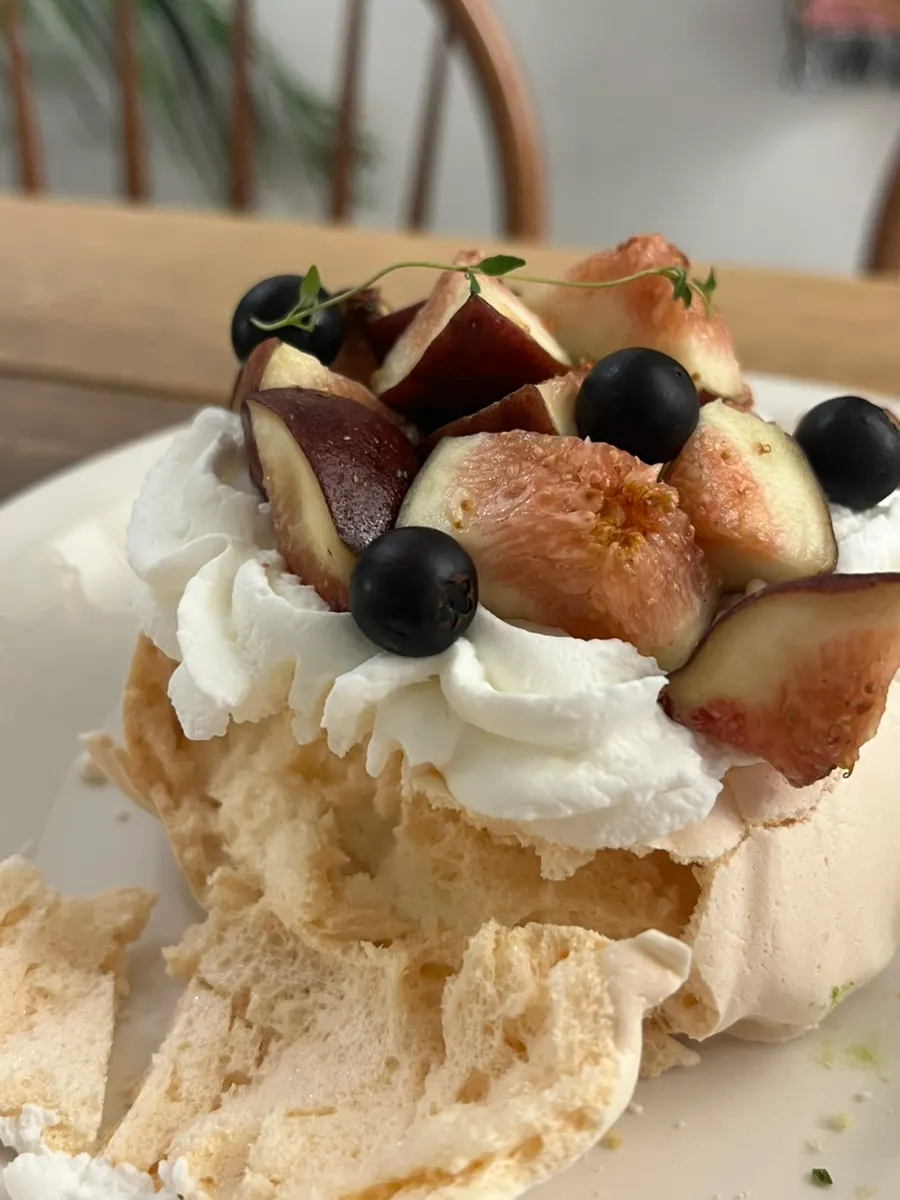 Fig pavlova showing its meringue and cream layers