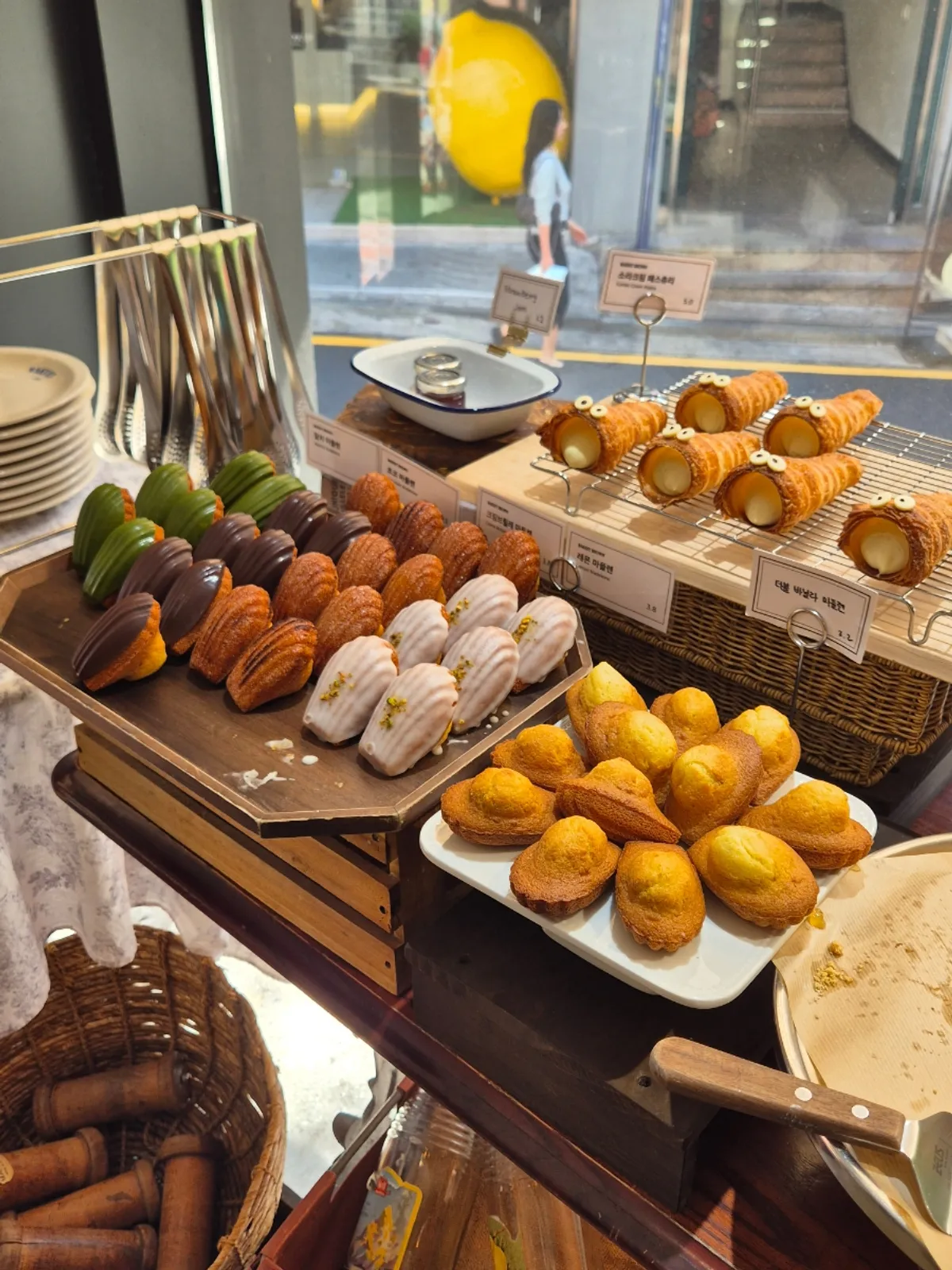 Bakery counter with madeleines and baked goods