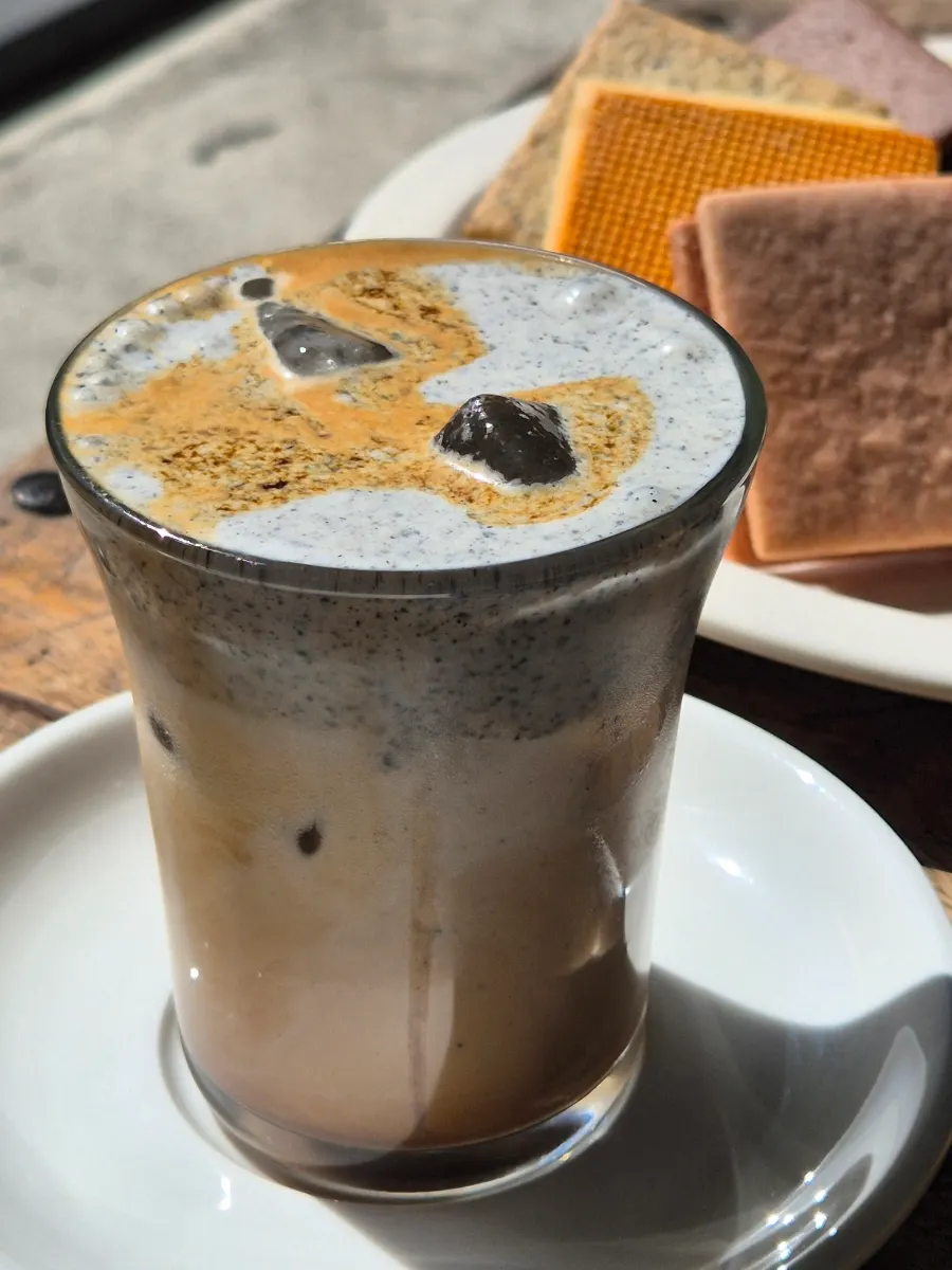 Iced black sesame latte topped with black sesame cream