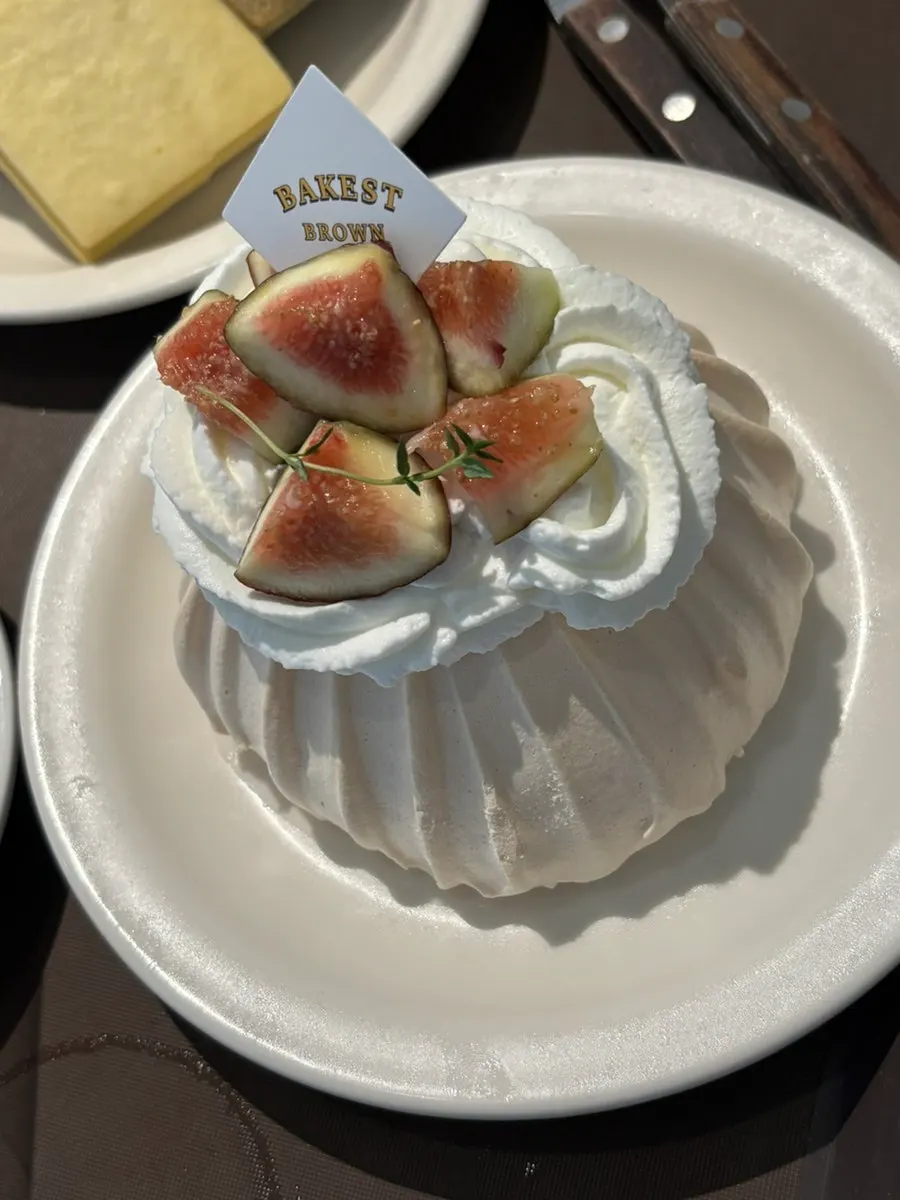 Fig pavlova topped with cream and figs