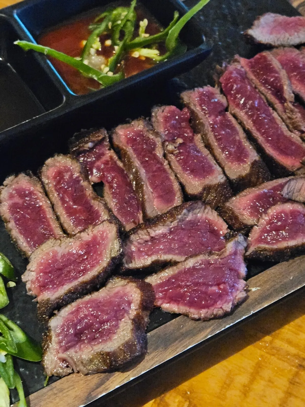 A single piece of lightly seared Korean beef tataki