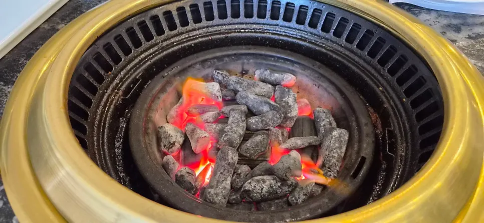 Grill filled with strong-burning real charcoal