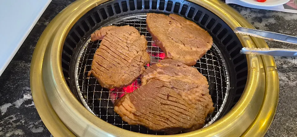 Scene of ribs grilling over charcoal