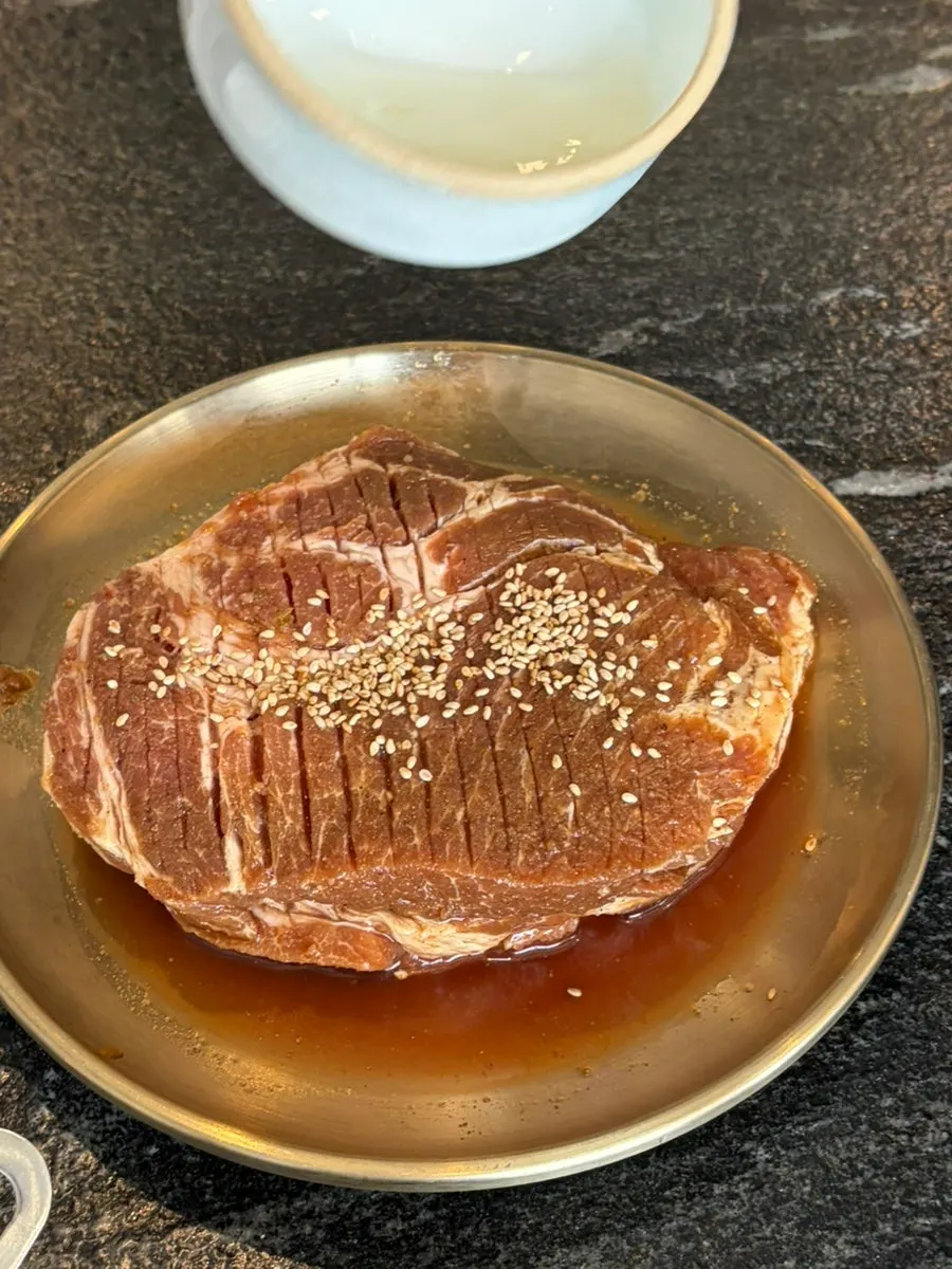 Marinated pork ribs grilling over charcoal