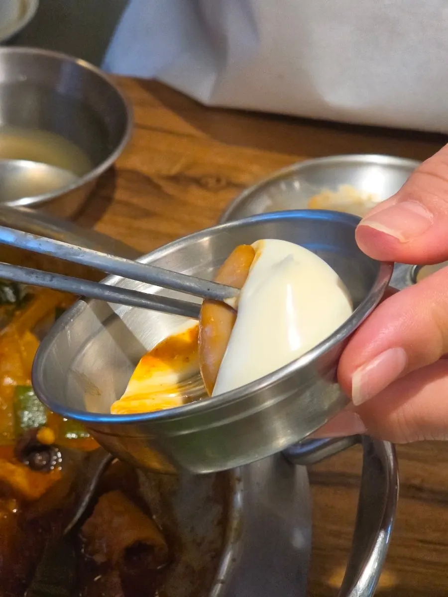 A bite of nakgopsae with mayonnaise