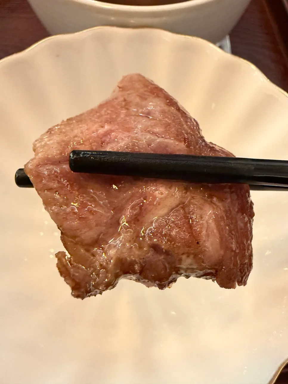 A slice of sirloin steki grilling on the tabletop grill