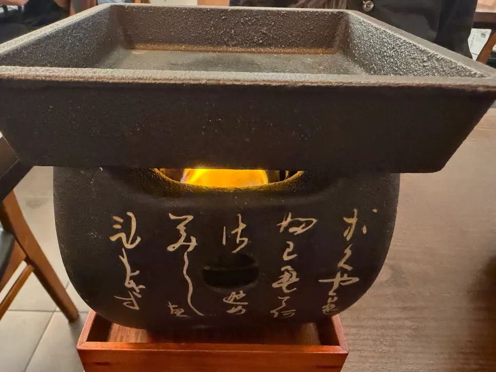 Staff lighting the personal tabletop grill to heat it up