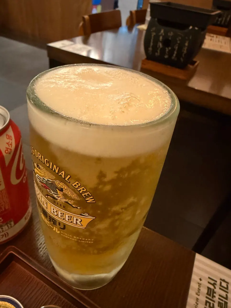 A glass of Kirin draft beer ordered alongside the gyukatsu