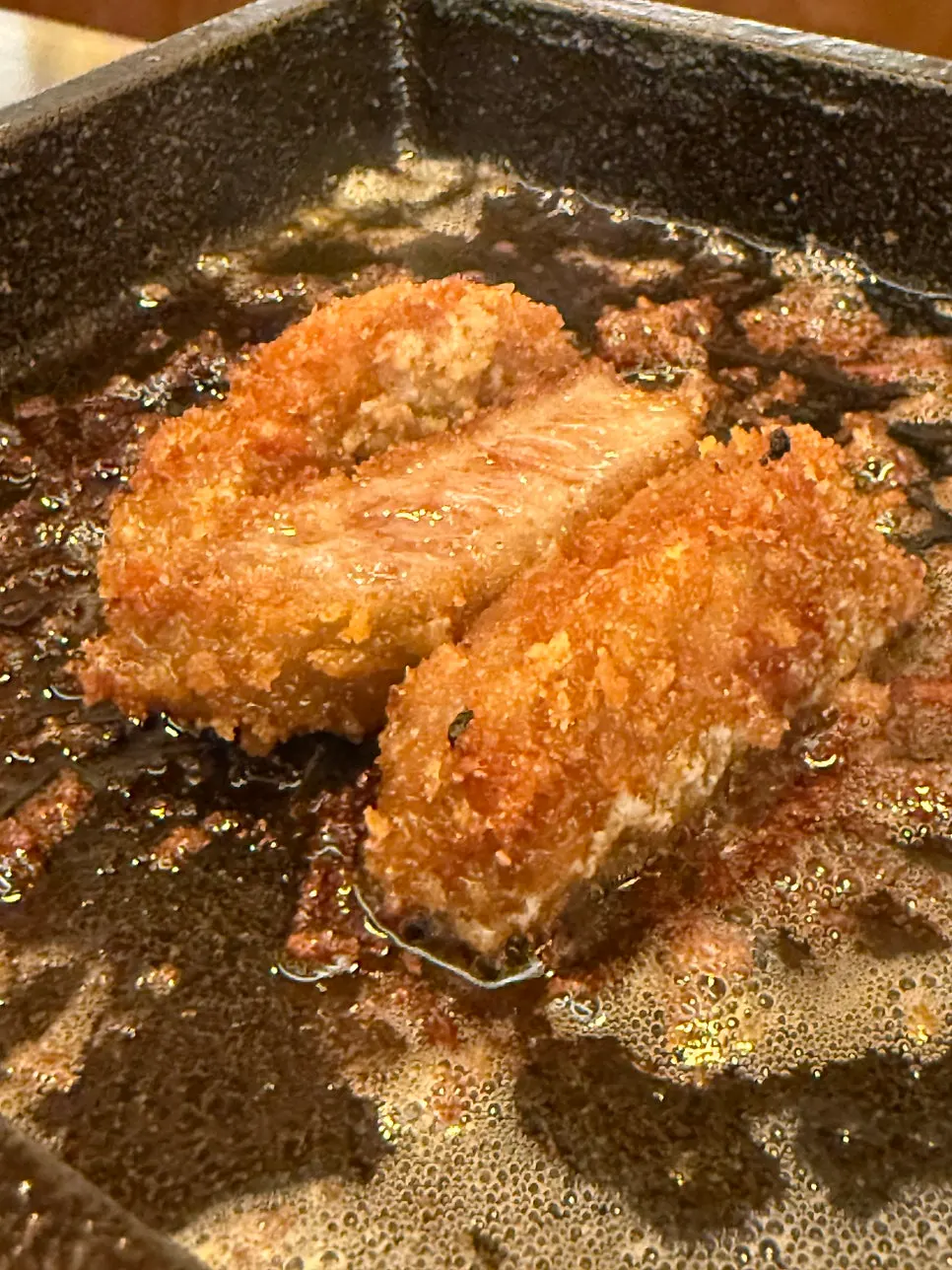 A slice of gyukatsu on the brazier