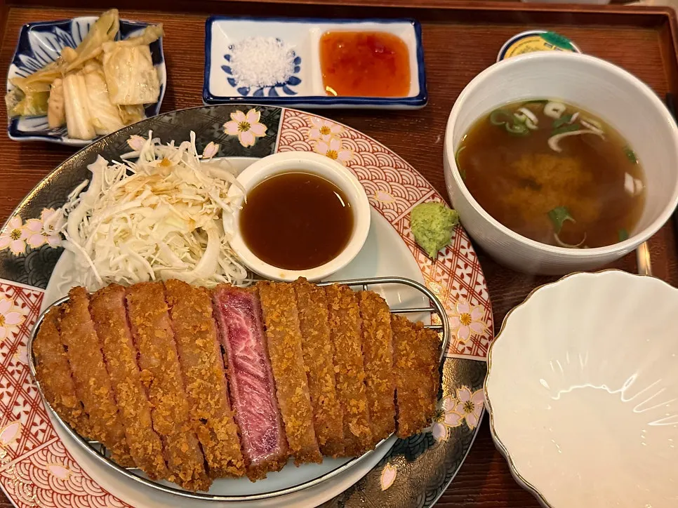 Enjoying gyukatsu and beer together at the table