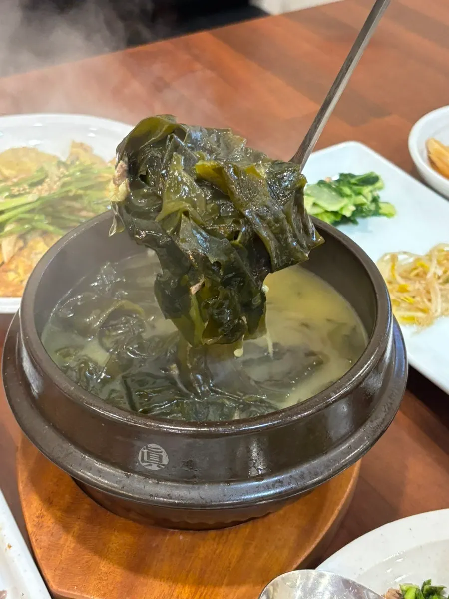 Earthenware bowl of beef seaweed soup loaded with beef