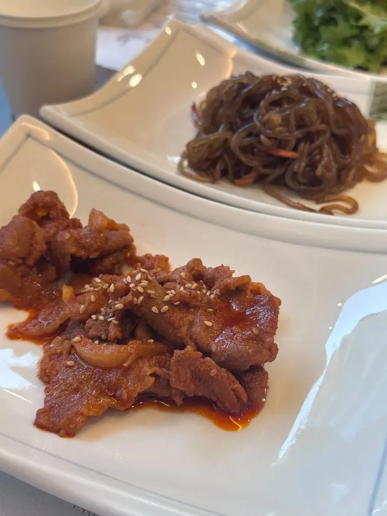 Japchae and stir-fried spicy pork side dishes