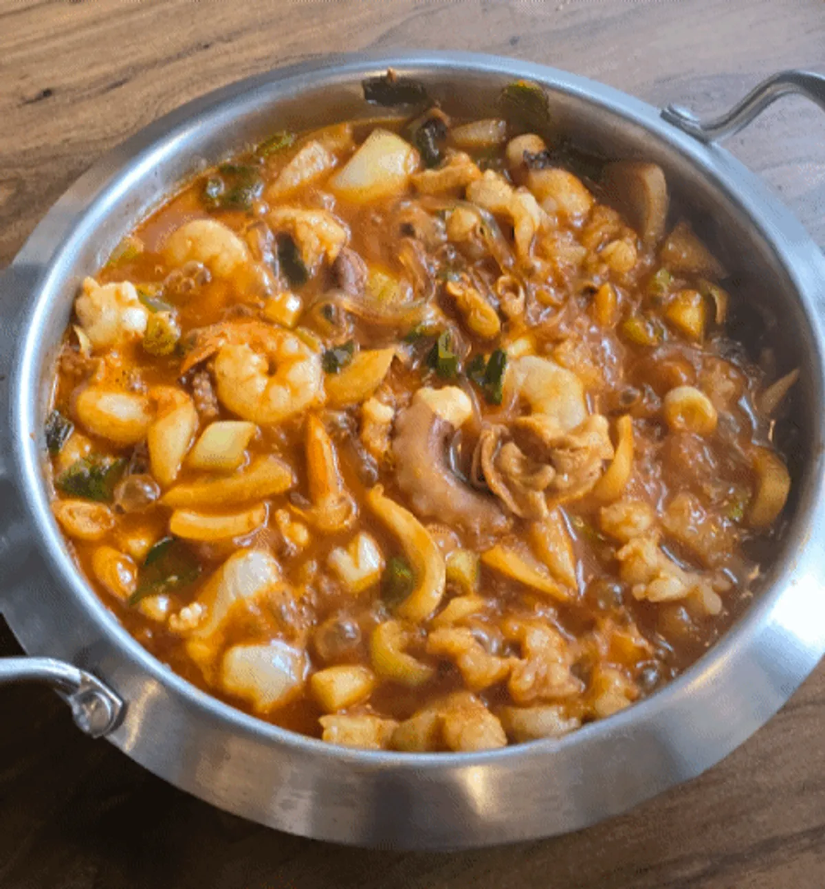 Beef intestine nakgopsae with glass noodles and rice cake sticks added
