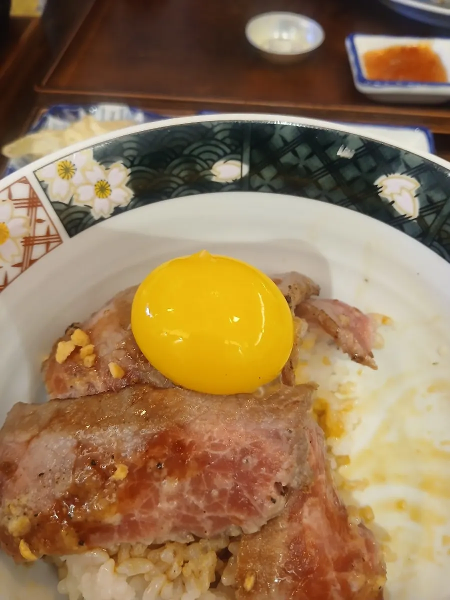 Steak-don topped with a raw egg yolk