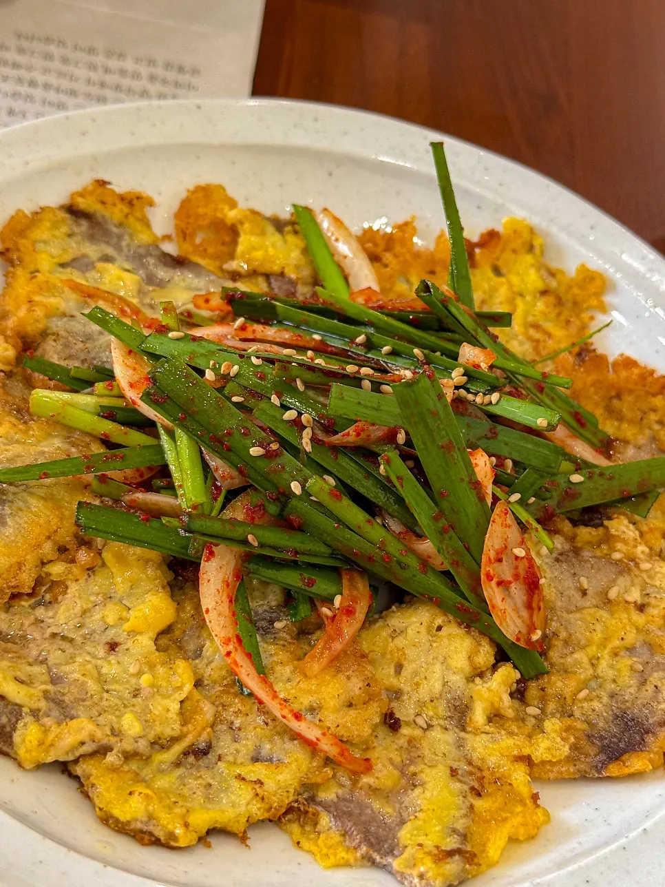 Mikodam's beef jeon plate topped with chive salad