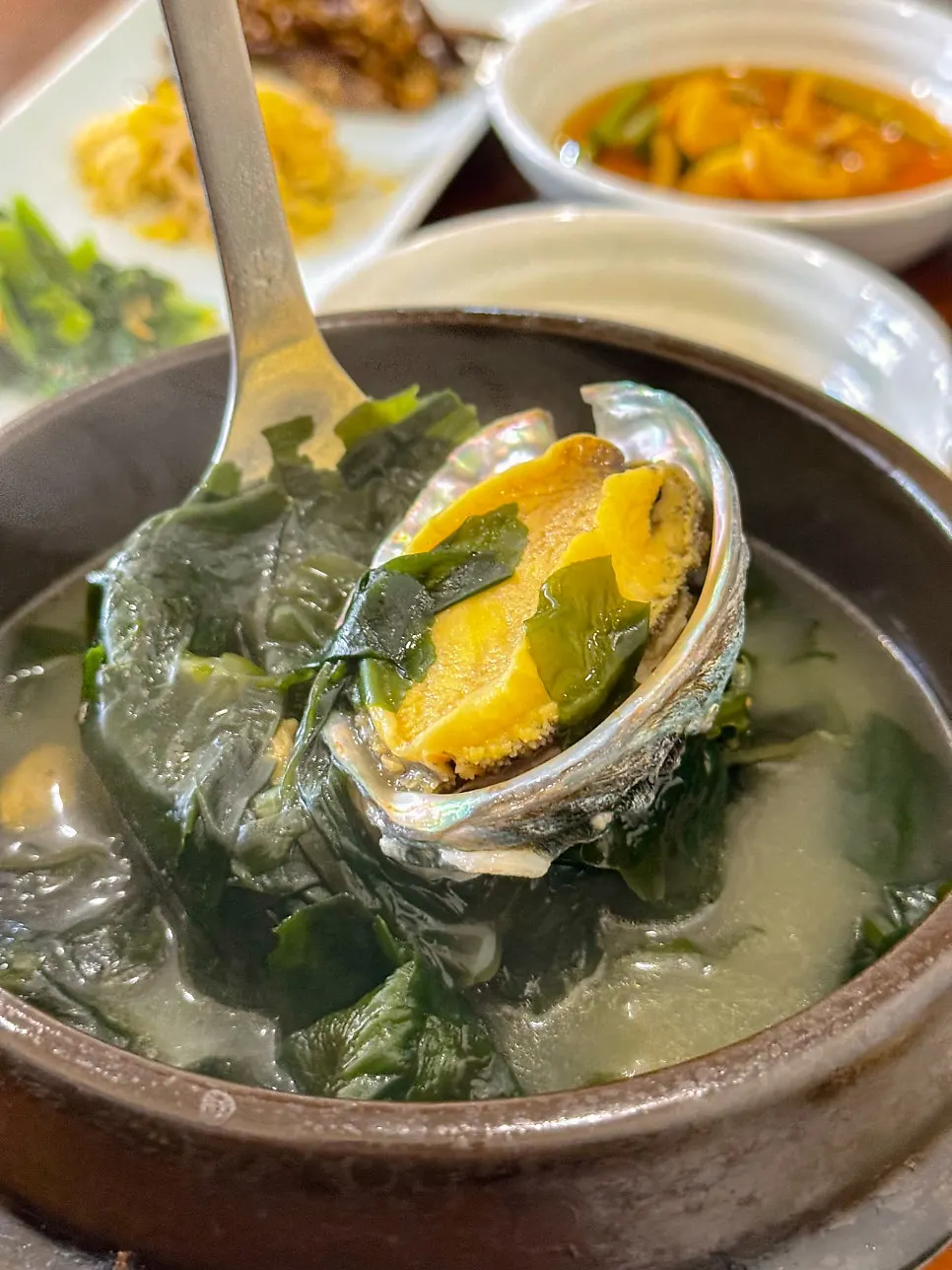 Abalone seaweed soup with two whole abalones inside