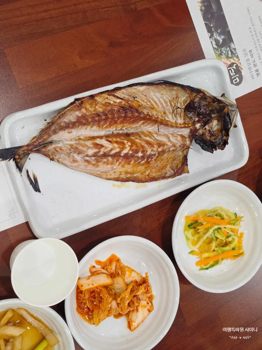 Complimentary grilled mackerel served as a side