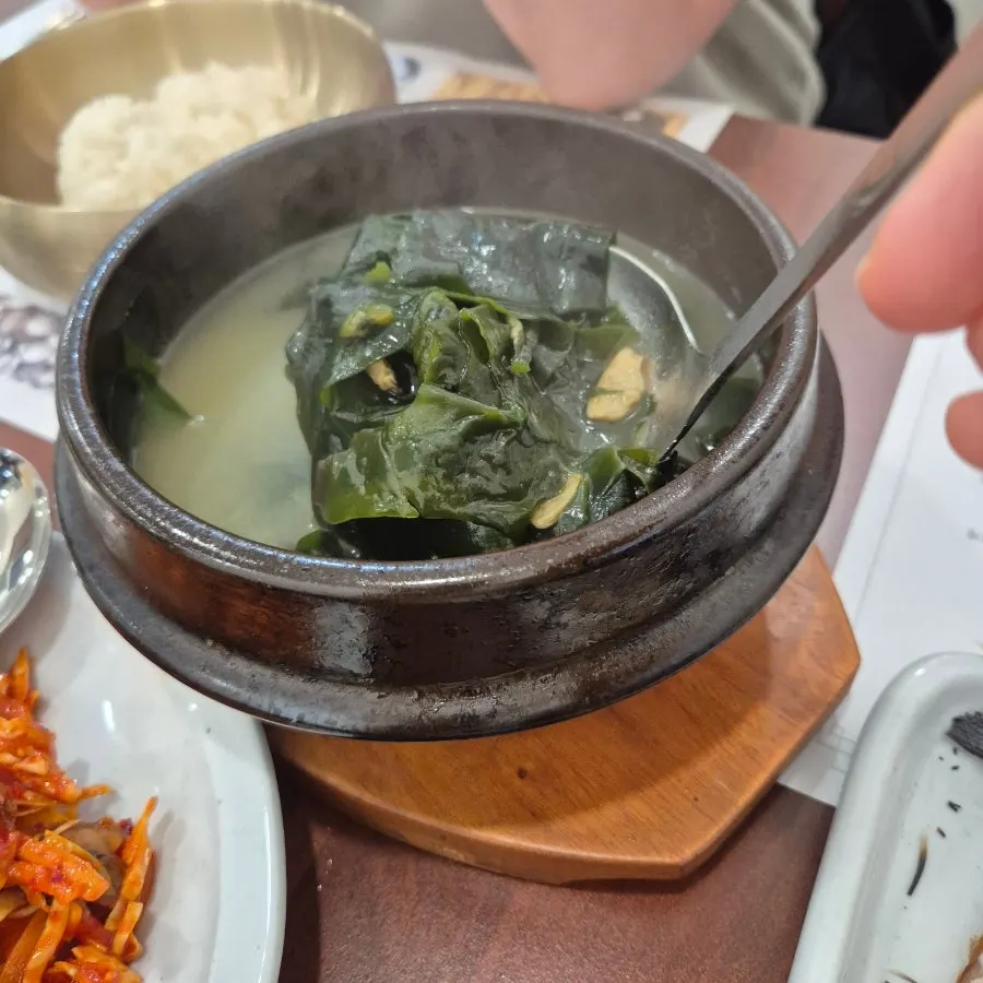 Two bowls of beef and cockle seaweed soup