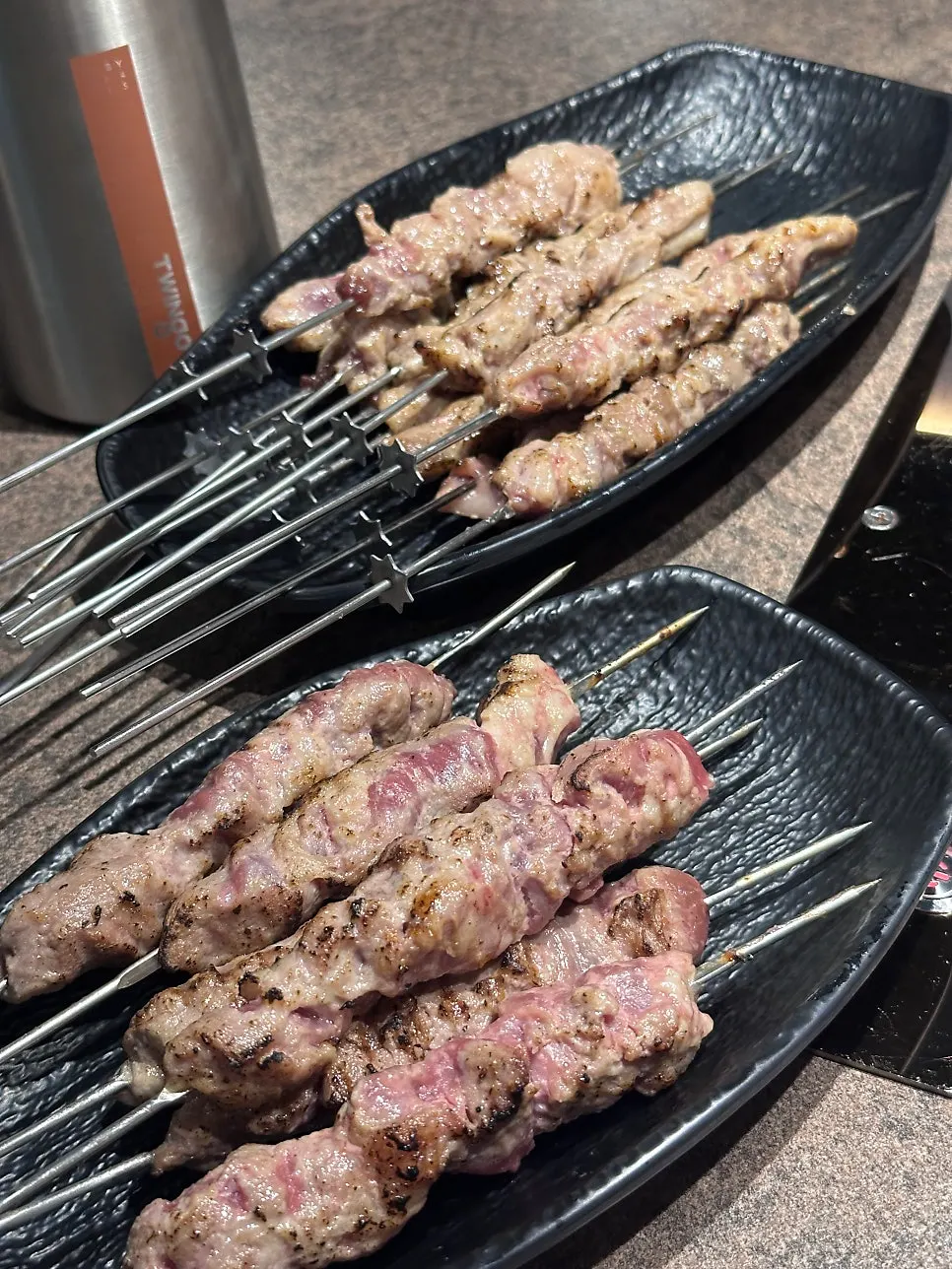 Lamb skewers eaten with several sauces
