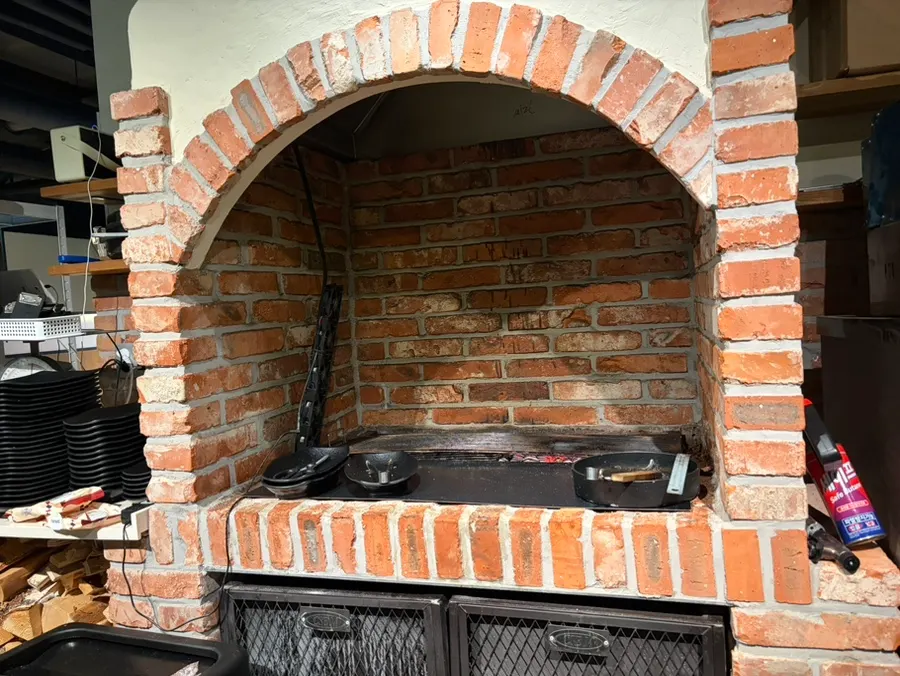 Charcoal oven at the entrance for pre-grilling skewers