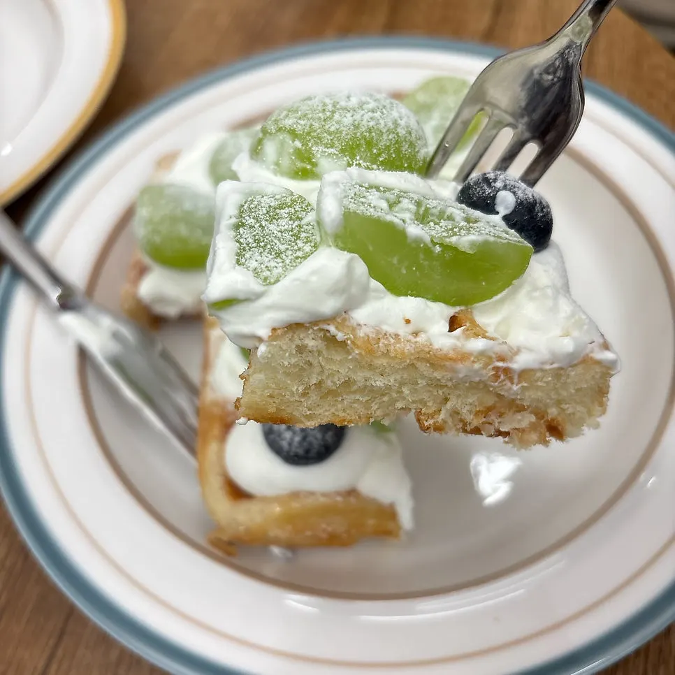 Waffle topped with whipped cream and fruit