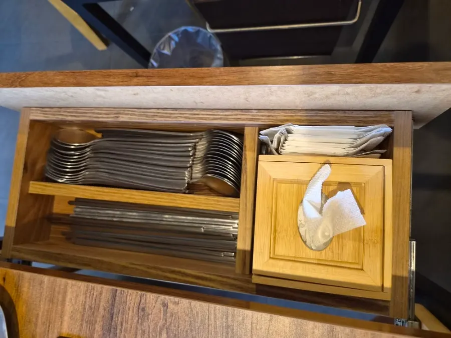 A utensil holder, napkins, and wet wipes on the table