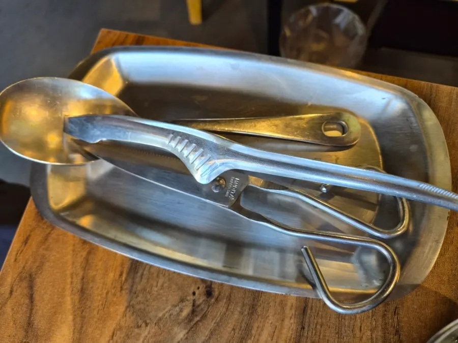 Scissors and a spatula arranged neatly on a dedicated tray