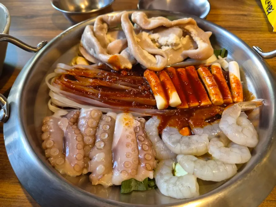 The nakgopsae hot pot starting to boil over the flame