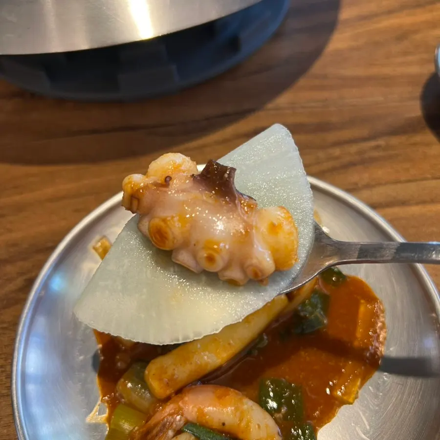 A full spread of gently spicy nakgopsae