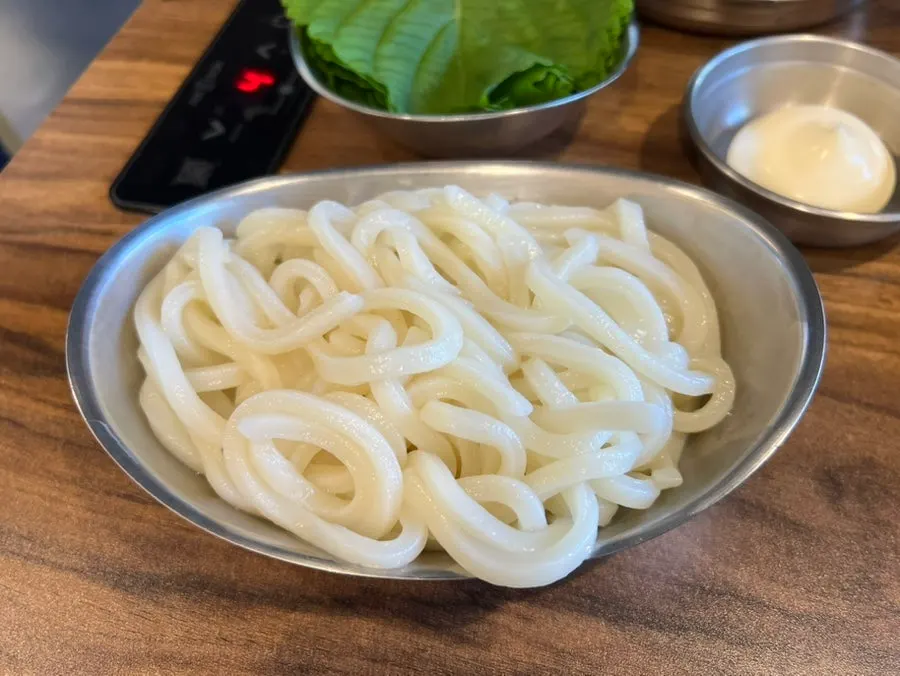 Nakgopsae with perilla leaves and pickled radish wraps