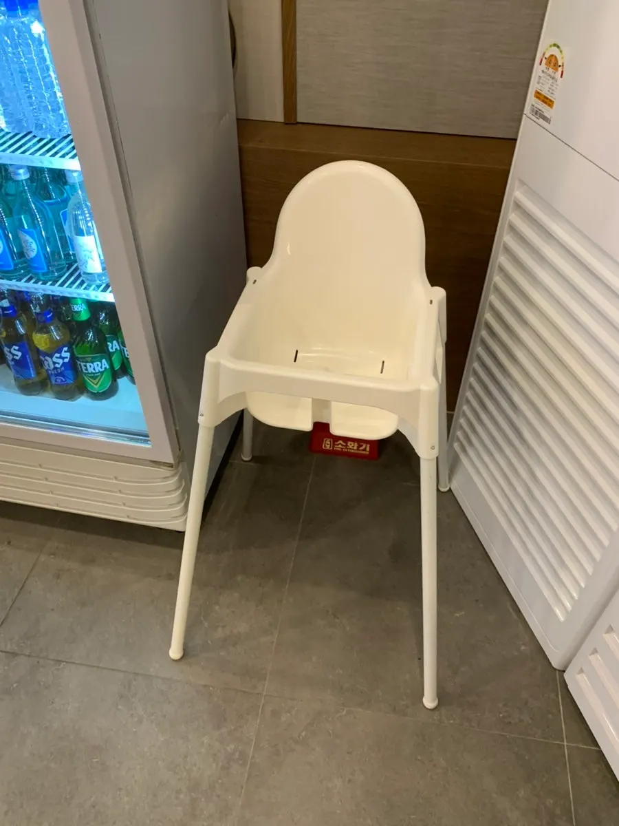 Table seating with bottled water and a baby chair