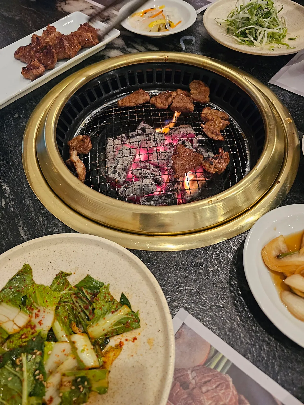 Marinated pork grilling over charcoal