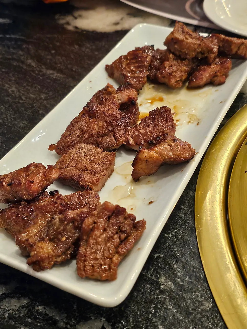 A staff member grilling marinated pork