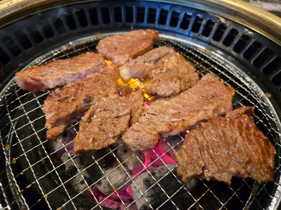 Marinated ribs grilled by a staff member