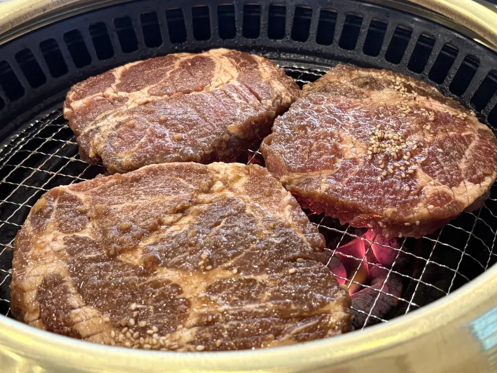 Staff member grilling marinated pork ribs