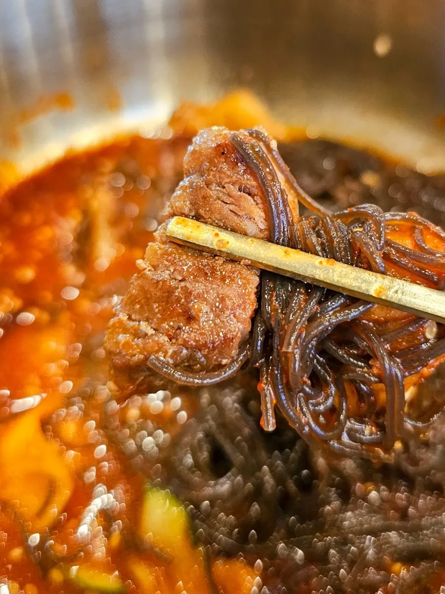Bibim naengmyeon and meat table setting