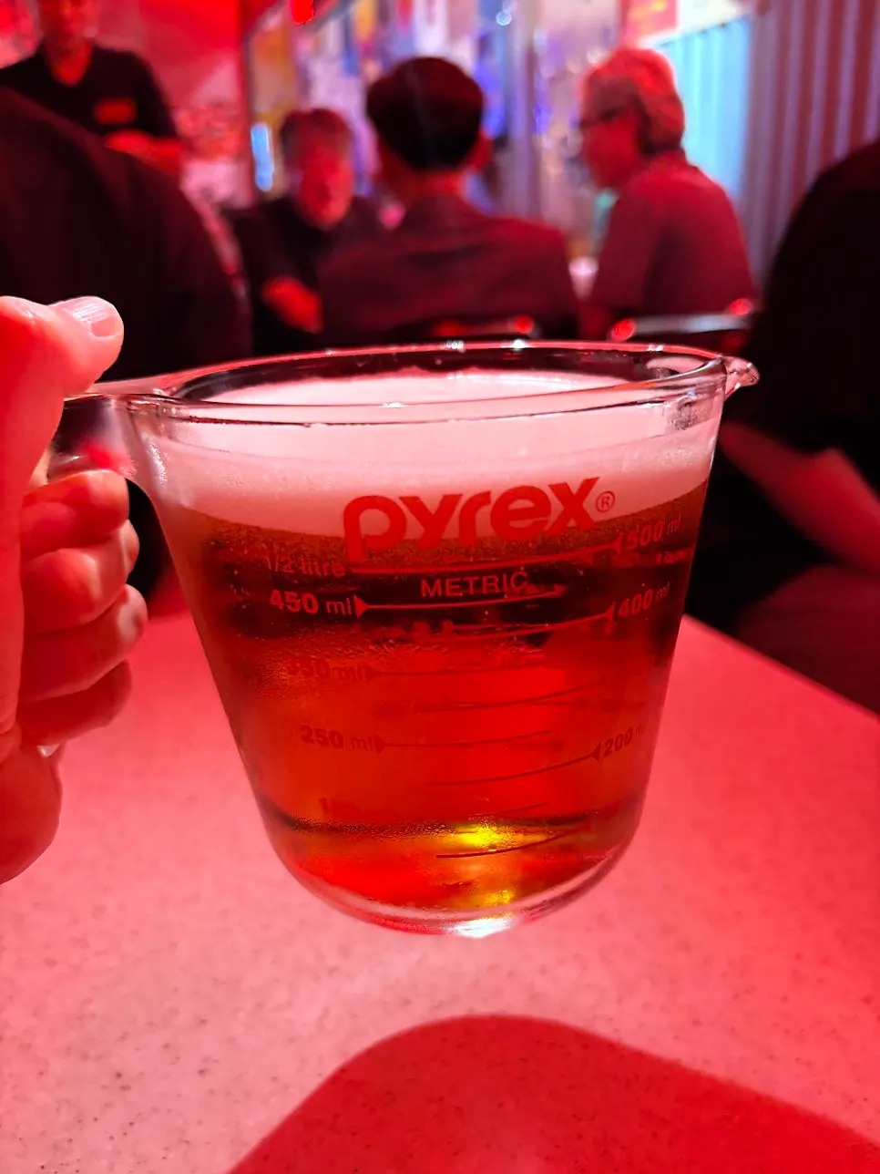 A 500 draft beer served in a measuring-cup-style glass