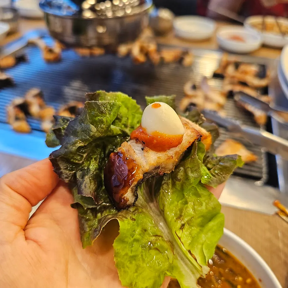 Thick cuts of eel cooking on the grill