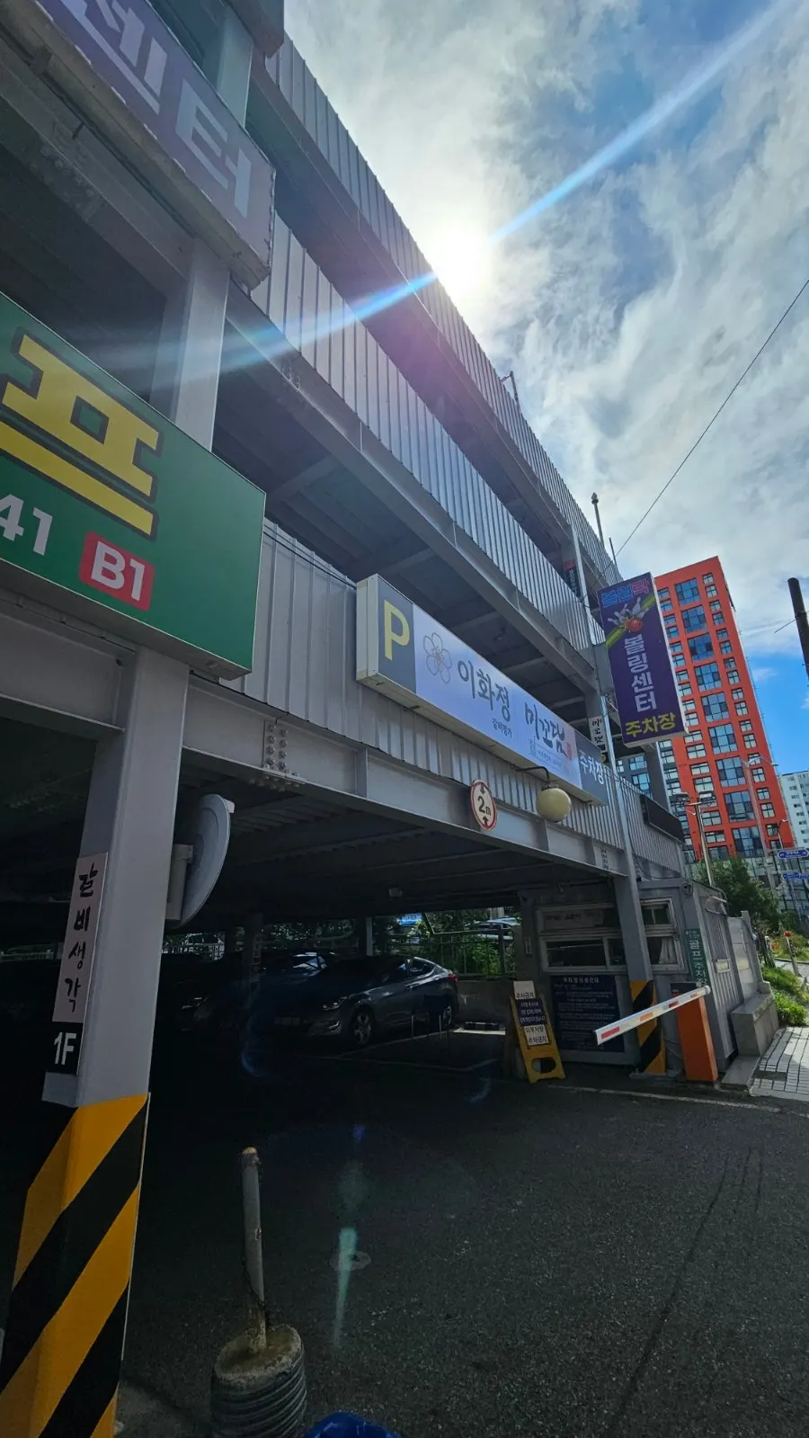 The large 4-floor parking tower beside the building