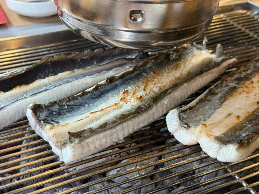 Eel being grilled with the fins neatly trimmed