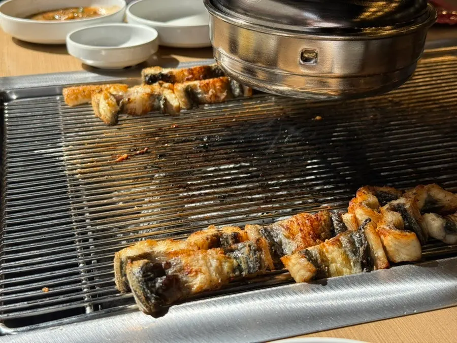 Eel being flipped for final grilling