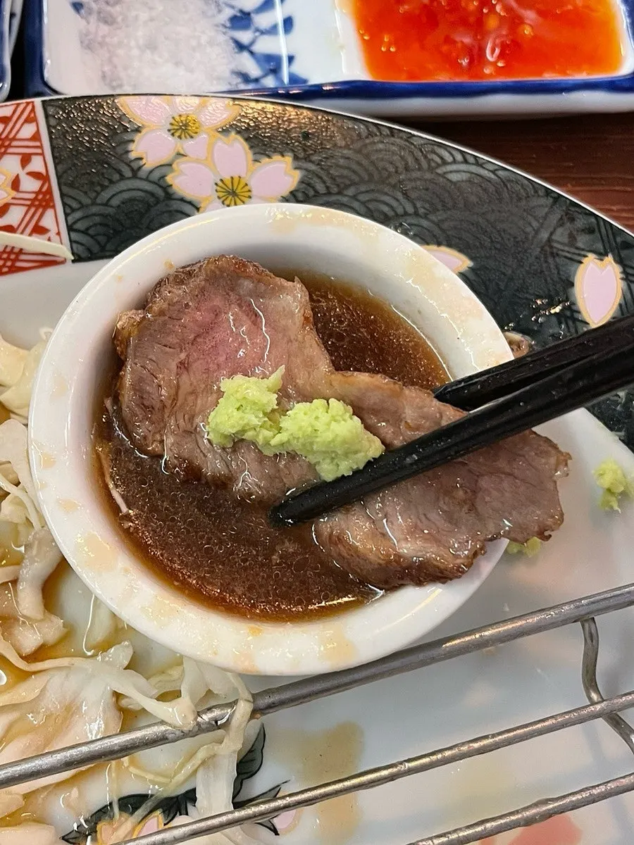 A piece of steki dipped in special sauce