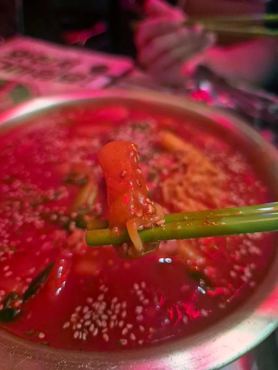 Scooping up the tteokbokki broth