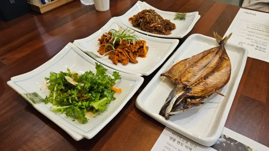 Side dishes being set out one by one for the full spread