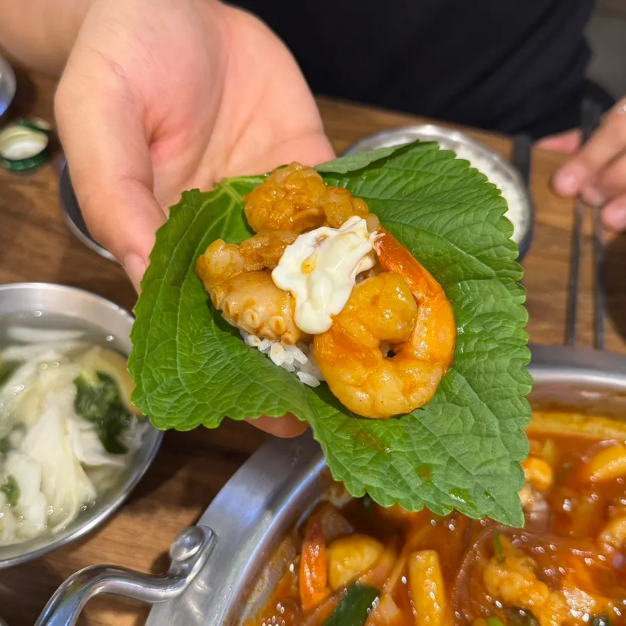 A perilla leaf wrap with nakgopsae and mayonnaise