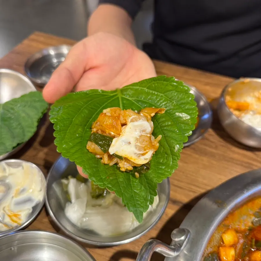 A perilla leaf wrap topped with octopus and beef intestine